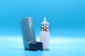 Asthma inhaler with cartridge for breathing disease treatment on blue background