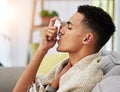 Asthma, sofa and person with inhaler due to cold, flu and fever in a home living room with a blanket on couch