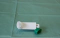 Asthma spray colored medicinal inhaler with the cap on the medical oilcloth. Inhaler from flu Royalty Free Stock Photo