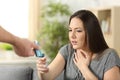 Asthmatic girl suffering an attack and receiving inhaler Royalty Free Stock Photo