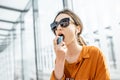 Asthmatic woman using inhaler outdoors Royalty Free Stock Photo