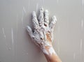 Astist plastering man hand with cracked plaster