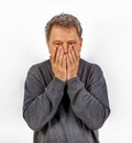 Astonished anxious man has hands in the face Royalty Free Stock Photo