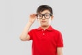 Astonished boy in glasses and red t-shirt goggling Royalty Free Stock Photo