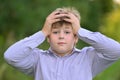 Astonished boy holding his hands behind head Royalty Free Stock Photo