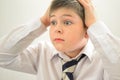 Astonished boy holding his hands behind his head Royalty Free Stock Photo