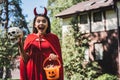 astonished child in demon costume screaming