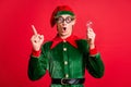 Astonished elf raise finger up hold light bulb clever think concept wear green costume isolated on red shine color Royalty Free Stock Photo