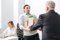 Astonished employee receiving the box with belongings from the employer