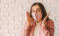 Astonished excited hipster girl in pink medical face mask feel surprised Royalty Free Stock Photo