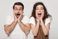 Astonished millennial guy and woman winners amazed by unbelievable news.