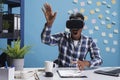 Astonished scared office worker wearing virtual reality headset while enjoying simulation game. Royalty Free Stock Photo
