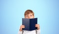 Astonished schoolboy with book, blue Royalty Free Stock Photo