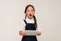 astonished schoolkid with digital tablet looking