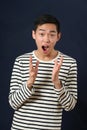 Astonished young Asian man gesturing with two hands Royalty Free Stock Photo