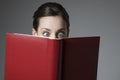 Astonished Young Female Reading Book With Eyes Wide Open Royalty Free Stock Photo