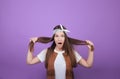 Astonished young lady holds her hair in her hands