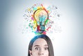Astonished young woman and her bright idea Royalty Free Stock Photo