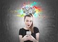 Astonished young woman, smartphone, cog brain Royalty Free Stock Photo