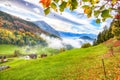 Astonishing autumn view on suburb of Hergiswil village with mountaines and fog