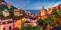 Astonishing evening cityscape of Riomaggiore, first city of the Cique Terre sequence of hill cities . Fantastic sunset in Liguria