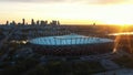 Astonishing sunrise over the Warsaw National stadium with purple sky and golden sun