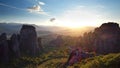 Astonishing view of Meteora valley at sunset, rays running across rocks and over Rousanou nunnery and St Nicholas