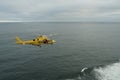 Flying yellow helicopter of Columbia River Bar Pilots ready for embarking and transferring pilots