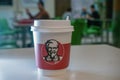 Astrakhan Russia 13 Feb. 2019: KFC fast food takeaway coffee cup with famous face of founder Kentucky Fried Chicken KFC
