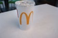 Astrakhan, Russia 13 Feb. 2019: McDonalds takeaway cola paper cup on table in shopping mall food court. McDonalds fast