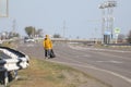 Astrakhan/Russia - May 1, 2020: A lonely man with a bag wanders down the highway.