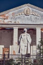 Astrakhan / Russia - May 29, 2020: Monument to one of the Bolshevik revolutionaries Kirov in a medical mask. Park in the