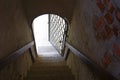 Astrakhan. Russia. Monastery. Steps leading down to an old metal-barred door. Royalty Free Stock Photo