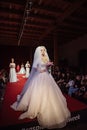 ASTRAKHAN RUSSIA - NOVEMBER 01, 2019. Caspian Fashion Week.Female models walk the runway in white wedding dresses Royalty Free Stock Photo