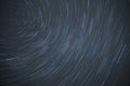 Astro photography time lapse of star trails rotating around the north polar star showing the rotation of earth Royalty Free Stock Photo