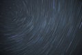 Astro photography time lapse of star trails rotating around the north polar star showing the rotation of earth Royalty Free Stock Photo