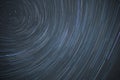 Astro photography time lapse of star trails rotating around the north polar star showing the rotation of earth Royalty Free Stock Photo