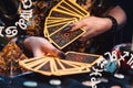 Astrology and divination. A fortune teller holds a fan of Tarot cards. Zodiac signs are shown in the corners. On the table are Royalty Free Stock Photo