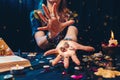 Astrology and esoterism. A sorcerer holds a flaming stones with the sign of the zodiac. Close up. The concept of Royalty Free Stock Photo