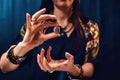 Astrology and horoscope. A woman holds a stone with the sign of the zodiac leo. Close up. The concept of divination and