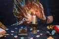 Astrology and online divination. A fortune teller does online fortune telling on photos from a smartphone. There are magic items Royalty Free Stock Photo
