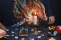 Astrology and online divination. A fortune teller does online fortune telling on photos from a smartphone. There are magic items