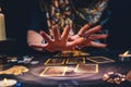 Astrology. The sorceress conjures over the tarot cards spread out on the table. Hands close-up. The concept of magic and Royalty Free Stock Photo