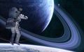 Astronaut on background of blue planet with a system of rings in far space. Science fiction Royalty Free Stock Photo