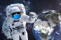 Astronaut in blue medical mask near night Earth planet in outer space Royalty Free Stock Photo