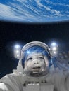 Astronaut child in space suit pointing at Earth