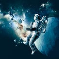 Astronaut floating in space. New worlds and unexplored galaxies. Asteroids and planet