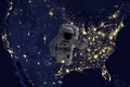 Astronaut flying in open space over the USA during night, near earth. Image made of NASA photos f