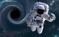 Astronaut in a front of black hole somewhere in space