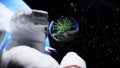 Astronaut and grass in glass sphere in outer space. Ecology concept. 3d rendering. Royalty Free Stock Photo